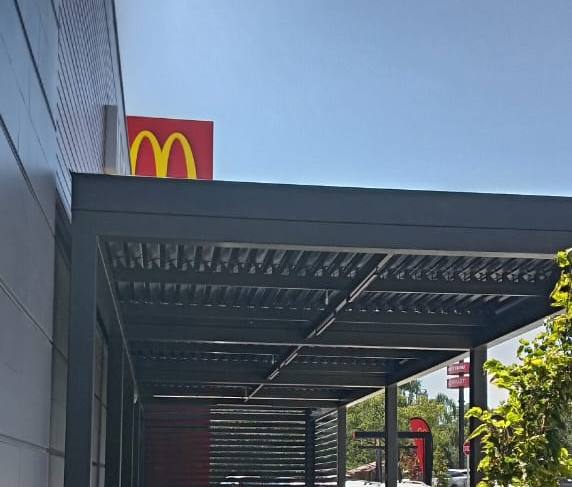 Charcoal entrance canopy and slat screening at McDonald's Bethlehem