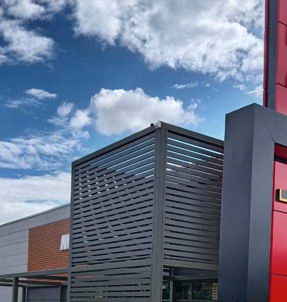 Charcoal aluminium slat screen box against a blue sky at McDonald's Bethlehem