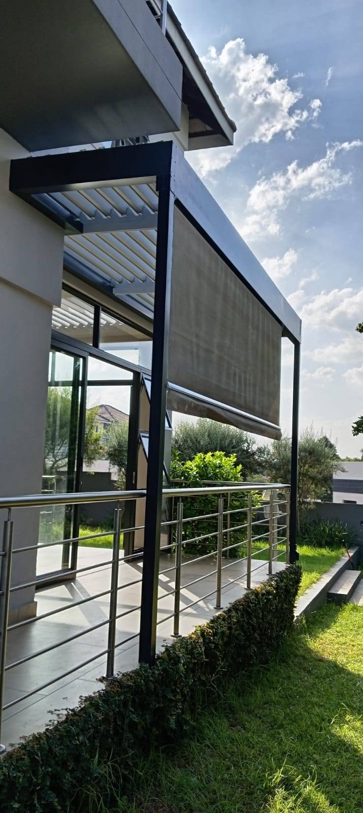 Fabric drop blind lowered along the garden-facing edge of the Bryanston louvre
