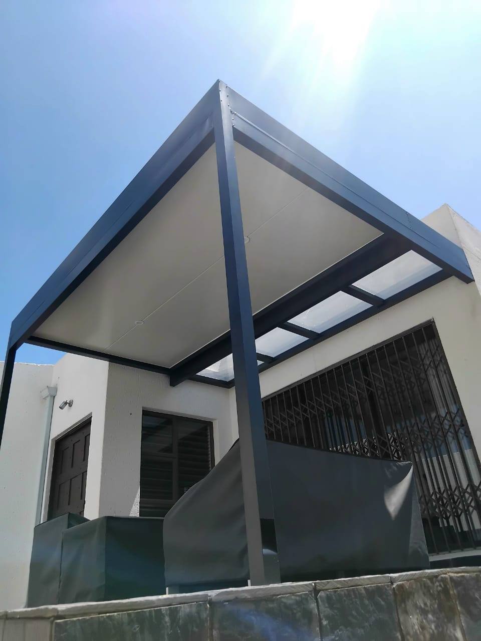 The charcoal-framed ceiling seen from the patio corner