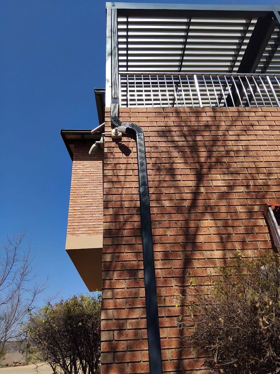 Gutter and downpipe detail running down the brickwork at Muldersdrift