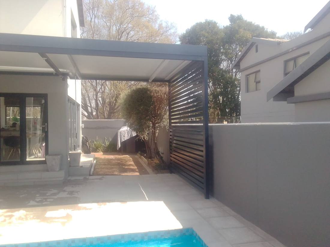 The slat screen seen across the pool courtyard